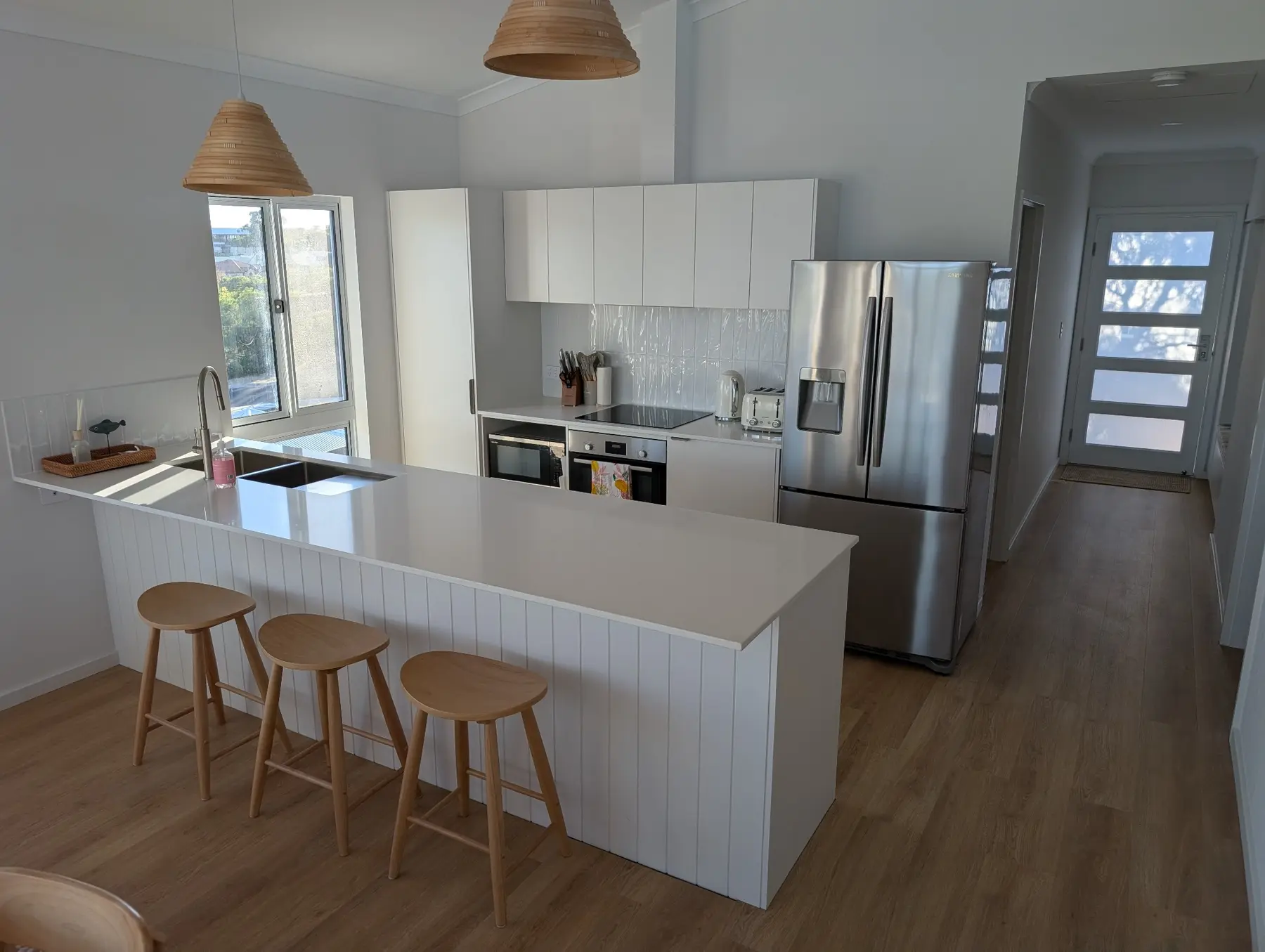 White kitchen and island bench inside the completed Binningup home by Capsule Builders